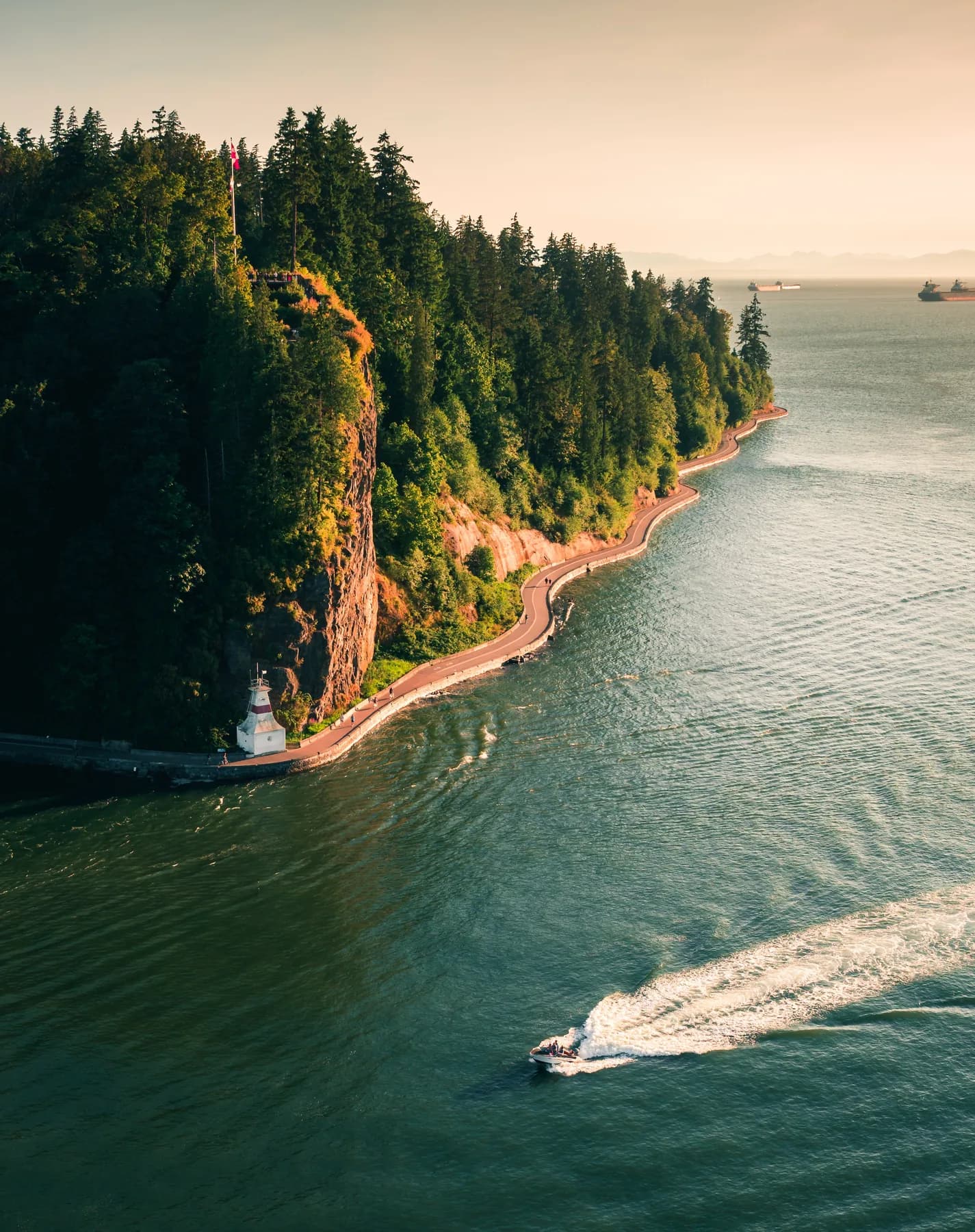 A quiet coastal landscape with water and forested mountains
